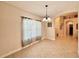 Bright dining area with tiled floors and natural light from sheer-curtained windows at 31728 Nutmeg Ave, Eustis, FL 32736