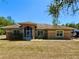 Charming single-story home featuring a screened porch and well-maintained landscaping in a quiet neighborhood at 31728 Nutmeg Ave, Eustis, FL 32736