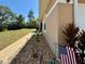 Close up of a home exterior with manicured landscaping and an American flag at 31728 Nutmeg Ave, Eustis, FL 32736