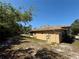 Side view of the home featuring a tan stucco exterior and screened lanai at 31728 Nutmeg Ave, Eustis, FL 32736