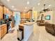 Open kitchen with stainless steel appliances, wooden cabinets, and bar seating at 31728 Nutmeg Ave, Eustis, FL 32736