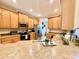 Well-lit kitchen with wood cabinets, stainless steel appliances and large countertops at 31728 Nutmeg Ave, Eustis, FL 32736