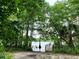 Scenic lake view with a sandy bank, trees, foliage and a wooden dock leading into the water at 31728 Nutmeg Ave, Eustis, FL 32736