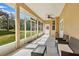 Enclosed back porch with ceiling fan, seating and view of backyard at 31728 Nutmeg Ave, Eustis, FL 32736