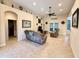 Open-concept living room featuring tile flooring and neutral-toned furniture at 31728 Nutmeg Ave, Eustis, FL 32736