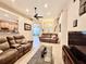 Cozy living room showcasing tile floors, comfortable sofas, and an open layout at 31728 Nutmeg Ave, Eustis, FL 32736