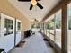 A relaxing screened porch featuring fans and comfortable seating arrangements at 31728 Nutmeg Ave, Eustis, FL 32736