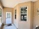 The exterior of a screened in porch with a light tan stucco wall at 31728 Nutmeg Ave, Eustis, FL 32736