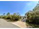 A suburban home with a long driveway and gated entrance is seen from the street at 31728 Nutmeg Ave, Eustis, FL 32736