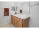 Bright bathroom featuring wood cabinets, a towel rack, and a large mirror at 3294 Shelby St, The Villages, FL 32162