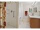 Bright bathroom featuring a walk-in shower and a wood vanity with a mirror at 3294 Shelby St, The Villages, FL 32162
