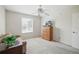 Cozy bedroom with a ceiling fan, large window, and a dresser with a television at 3294 Shelby St, The Villages, FL 32162