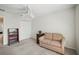 Bedroom featuring neutral colors, a closet and a cozy couch with an end table at 3294 Shelby St, The Villages, FL 32162