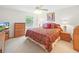 Comfortable bedroom with a large window, a plush bed, and matching nightstands at 3294 Shelby St, The Villages, FL 32162