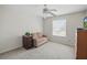 Cozy bedroom with a ceiling fan, large window, and a dresser with a television at 3294 Shelby St, The Villages, FL 32162
