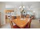 View from the dining room into the kitchen and living room, offering an inclusive living space at 3294 Shelby St, The Villages, FL 32162