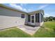 Back exterior view of the house with a patio, siding, and sunroom with access door at 3294 Shelby St, The Villages, FL 32162
