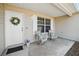 Cozy front porch featuring seating and a decorative wreath, offering a welcoming entrance to the home at 3294 Shelby St, The Villages, FL 32162