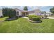 Well-maintained home featuring a lush lawn and charming landscaping at 3294 Shelby St, The Villages, FL 32162