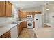 Functional kitchen with white appliances, ample counter space and tile floors at 3294 Shelby St, The Villages, FL 32162