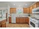 Well-lit kitchen featuring tile floors, white appliances, and ample counter space for cooking at 3294 Shelby St, The Villages, FL 32162