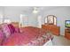 Main bedroom with mirrored dresser and ceiling fan at 3294 Shelby St, The Villages, FL 32162