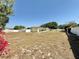 Large backyard, enclosed by white fencing, providing ample space and privacy around the property at 33415 Picciola Dr, Fruitland Park, FL 34731