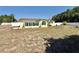 Exterior view of the house showing the expansive, fenced backyard perfect for outdoor activities at 33415 Picciola Dr, Fruitland Park, FL 34731