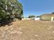 Spacious backyard enclosed by white fencing and mature trees, offering both privacy and a natural setting at 33415 Picciola Dr, Fruitland Park, FL 34731