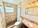 Walk-in shower with tiled walls, natural lighting, and a modern vanity at 33415 Picciola Dr, Fruitland Park, FL 34731