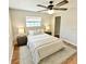 Cozy bedroom with plush bedding, soft lighting, and hardwood floors at 33415 Picciola Dr, Fruitland Park, FL 34731