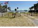 View of the community park with lake access, featuring a charming wooden fence and gate at 33415 Picciola Dr, Fruitland Park, FL 34731