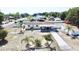 Charming single-story home with a covered porch, surrounded by palm trees and a white picket fence at 33415 Picciola Dr, Fruitland Park, FL 34731