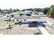 Aerial view capturing the home's layout, featuring fenced yard, landscaping and covered patio at 33415 Picciola Dr, Fruitland Park, FL 34731