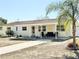 Inviting single-story home featuring a covered front porch and well-maintained landscaping at 33415 Picciola Dr, Fruitland Park, FL 34731