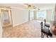 Inviting living area with tile flooring, two ceiling fans, and views into the hall and bar at 33415 Picciola Dr, Fruitland Park, FL 34731