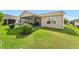 Relaxing backyard with a screened-in lanai and well-kept lawn, ideal for outdoor activities at 3396 Greenacres Ter, The Villages, FL 32163