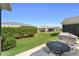 Private backyard with patio furniture, a grill, and views of surrounding properties at 3396 Greenacres Ter, The Villages, FL 32163