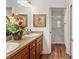 Bathroom featuring double sinks, wood cabinets, and a glass-enclosed shower at 3396 Greenacres Ter, The Villages, FL 32163