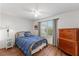 Comfortable bedroom with a brass bed frame, side table, and dresser by the window, creating a relaxing retreat at 3396 Greenacres Ter, The Villages, FL 32163