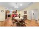 Open dining area and kitchen featuring wood cabinets and barstool seating at 3396 Greenacres Ter, The Villages, FL 32163