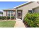 Charming home entrance with a well-manicured garden and a clear pathway to the door at 3396 Greenacres Ter, The Villages, FL 32163