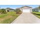 Charming home with an attached garage, well-maintained landscaping, and a clean driveway at 3396 Greenacres Ter, The Villages, FL 32163