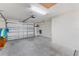 Spacious garage with a roll-up door, concrete floor, and ample space for parking and storage at 3396 Greenacres Ter, The Villages, FL 32163