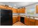Well-lit kitchen with wood cabinets, stainless steel sink, and modern appliances at 3396 Greenacres Ter, The Villages, FL 32163
