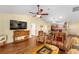 Open-concept living area featuring a TV and adjacent kitchen at 3396 Greenacres Ter, The Villages, FL 32163