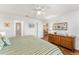 Bright main bedroom with wood-look floors, ceiling fan, and ample closet space at 3396 Greenacres Ter, The Villages, FL 32163
