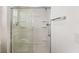 Modern glass-enclosed shower with built-in shelves and chrome fixtures at 3396 Greenacres Ter, The Villages, FL 32163