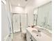 Clean, white bathroom featuring a glass-enclosed shower and modern sink at 34004 Sky Blossom Cir, Leesburg, FL 34788