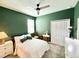 Comfortable bedroom with green painted walls, ceiling fan, window, and closet at 34004 Sky Blossom Cir, Leesburg, FL 34788